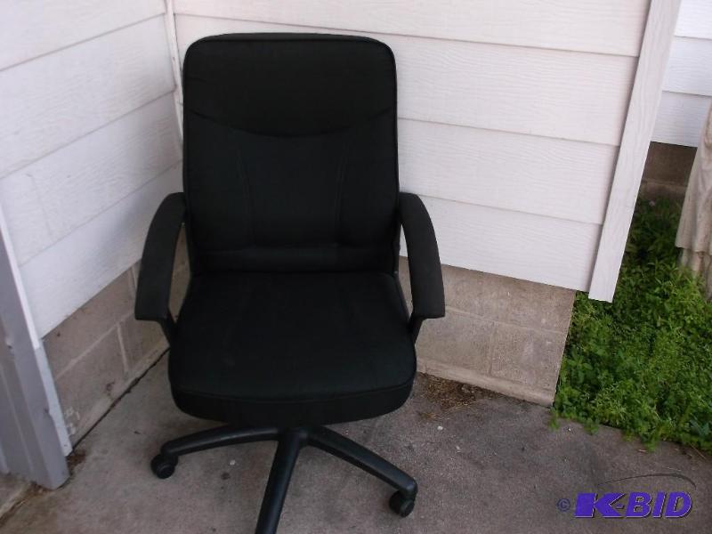 Black cloth office chair on wheels with seat ...