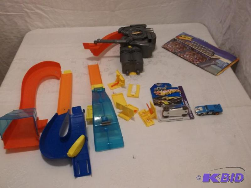 Hot Wheel race track with 2 cars appears to b...