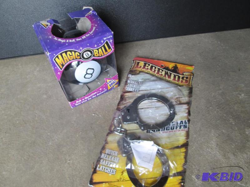 lot 14 image: Magic 8 ball and handcuff toys...