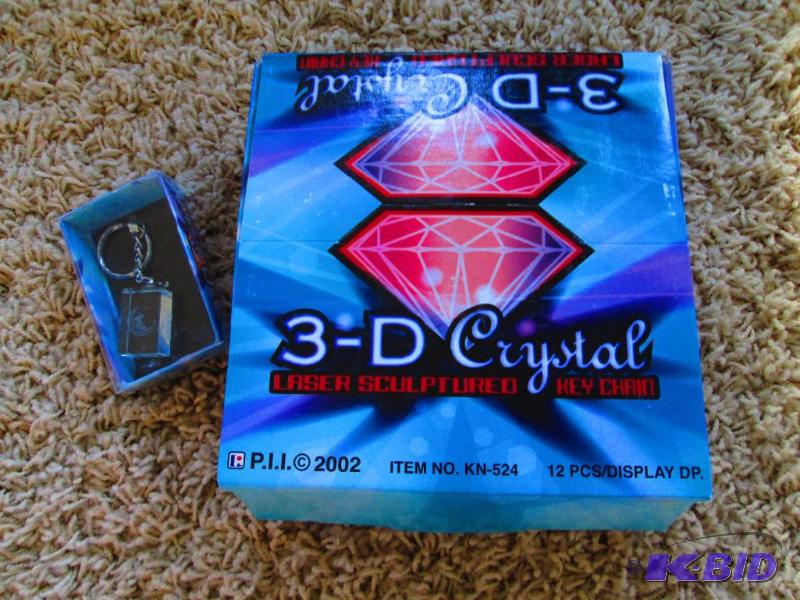 lot 210 image: Case of 12 assorted 3-D Crystal key ring acce...