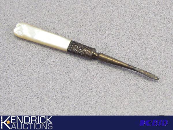 lot 37 image: Antique Sterling Silver Nail Manicure Piece With Mother of Pearl Handle
