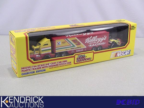 lot 56 image: New in Package Racing Champions Kelloggs Die Cast Cab, and Plastic Trailer with Premier Stock Car
