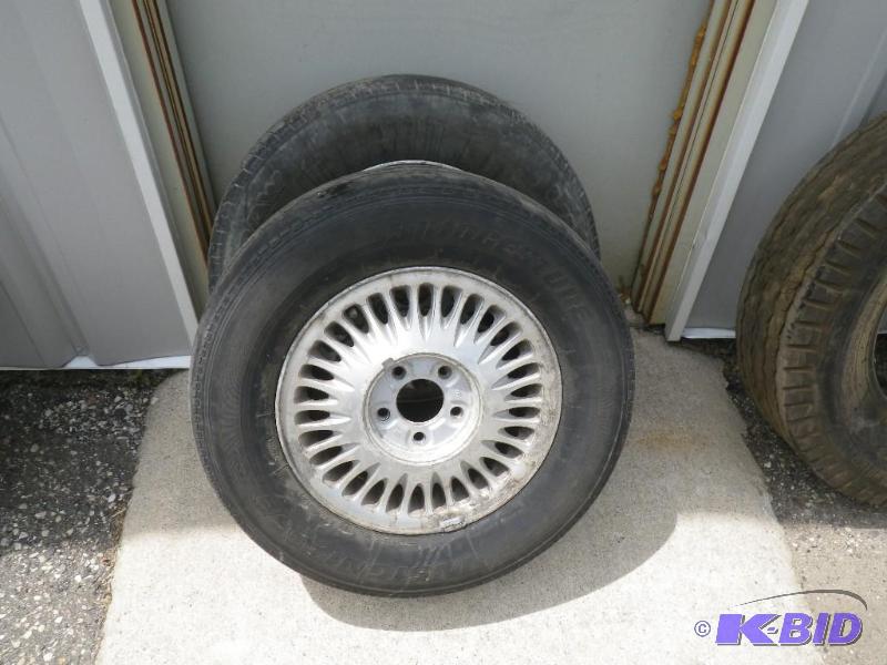 2 Bridgestone tires, 21570R15 on aluminum wh...