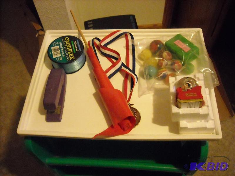 lot 89 image: plastic cubby on wheels, stapler, fishing str...