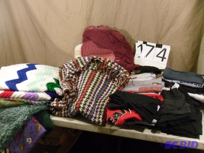 lot 174 image: Lot of Mens Tshirts, Rug, and Assorted Blanke...
