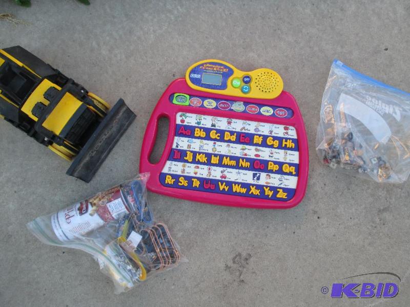 lot 125 image: Vtech game, toy car, and dice beads with smal...