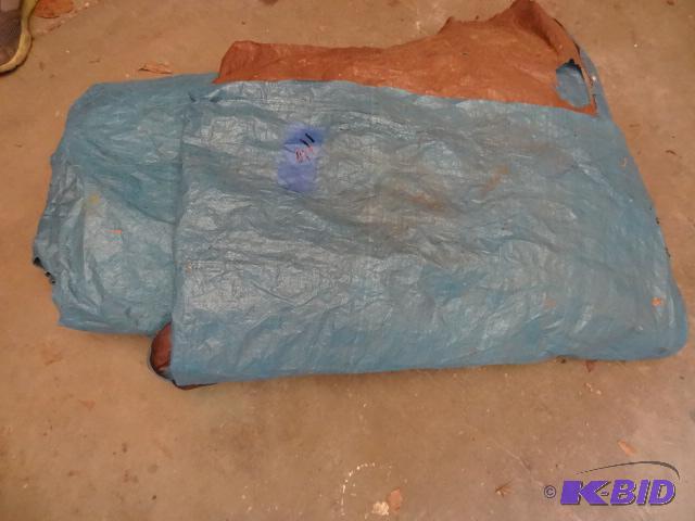 lot 116 image: Large blue tarp. Looks to be torn on edge...