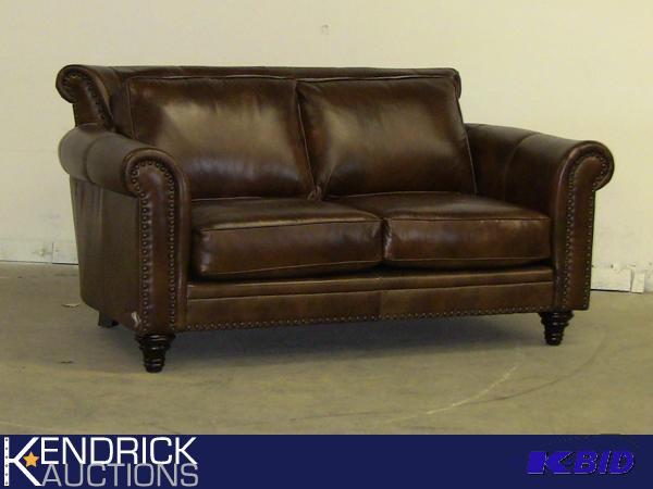 lot 22 image: New Colonial Brown Leather Loveseat