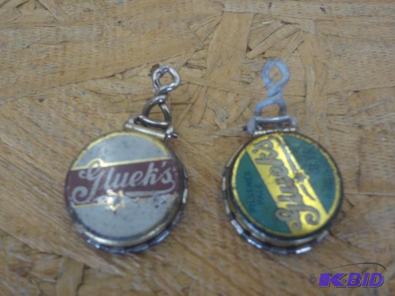 lot 140 image: (2) Gluek Bottle Cap Pendants...