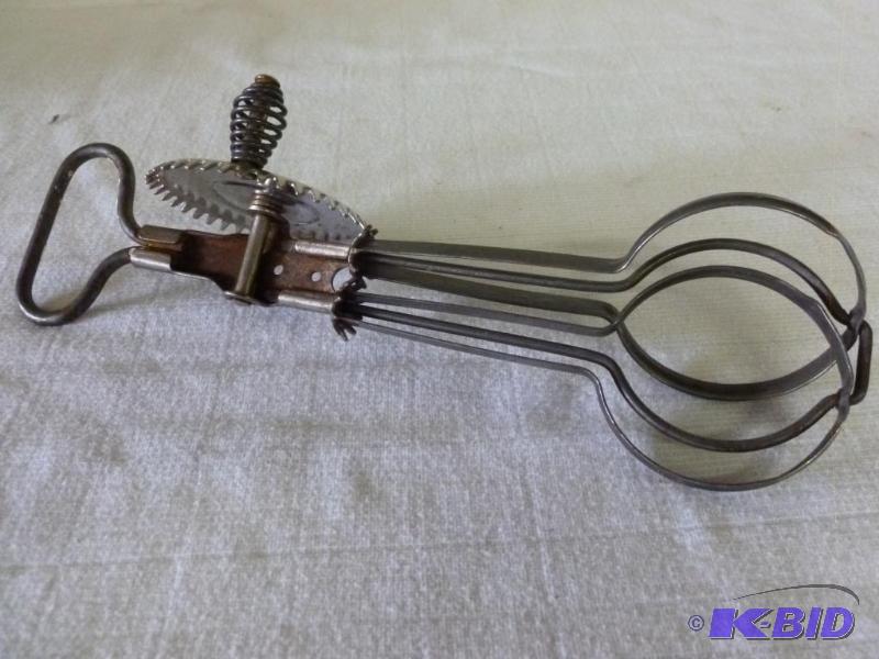 lot 123 image: Antique A & J egg beater that measures 10...