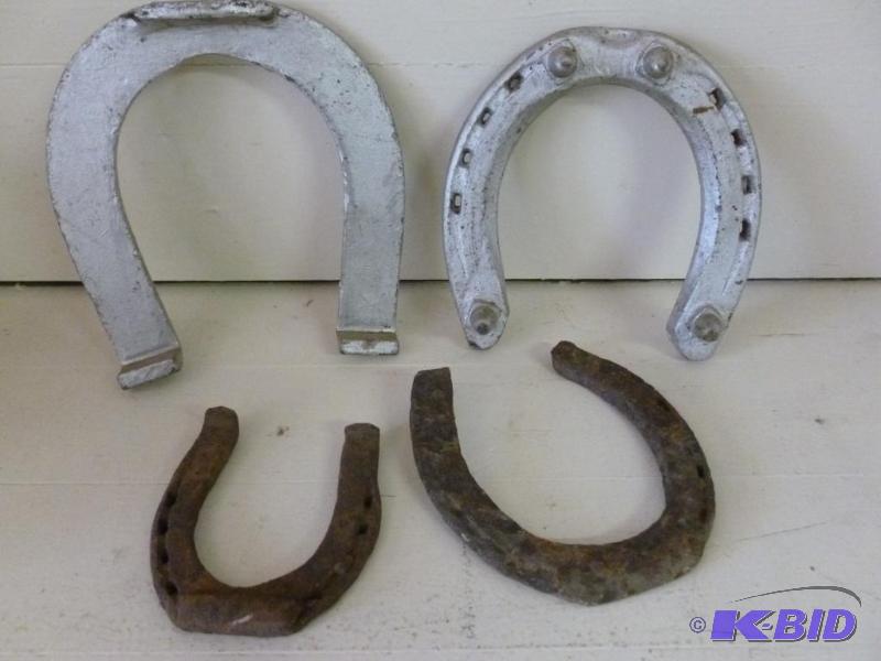 lot 179 image: Lot of four antique iron horseshoes....