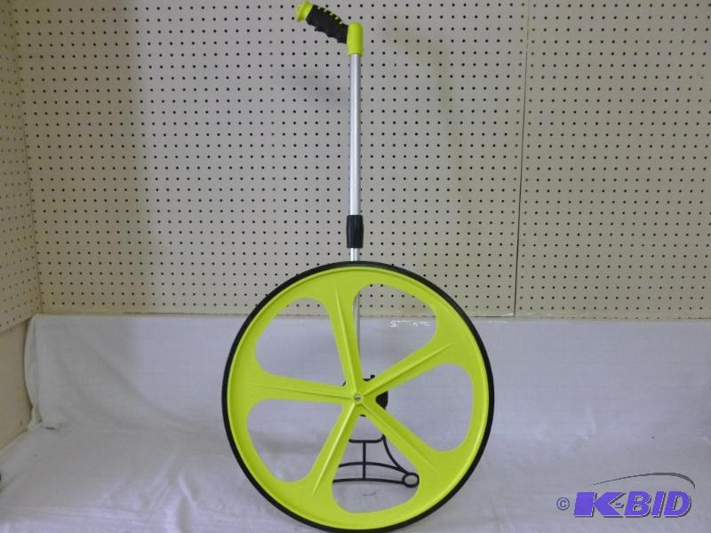 lot 232 image: Komelon Meter - Man outdoor measuring wheel, ...