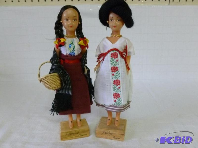 lot 35 image: Lot of two collectible dolls on wooden base, ...