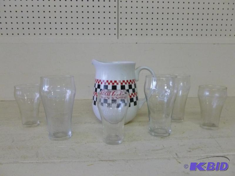 lot 74 image: Coca-Cola drink set that includes a large por...