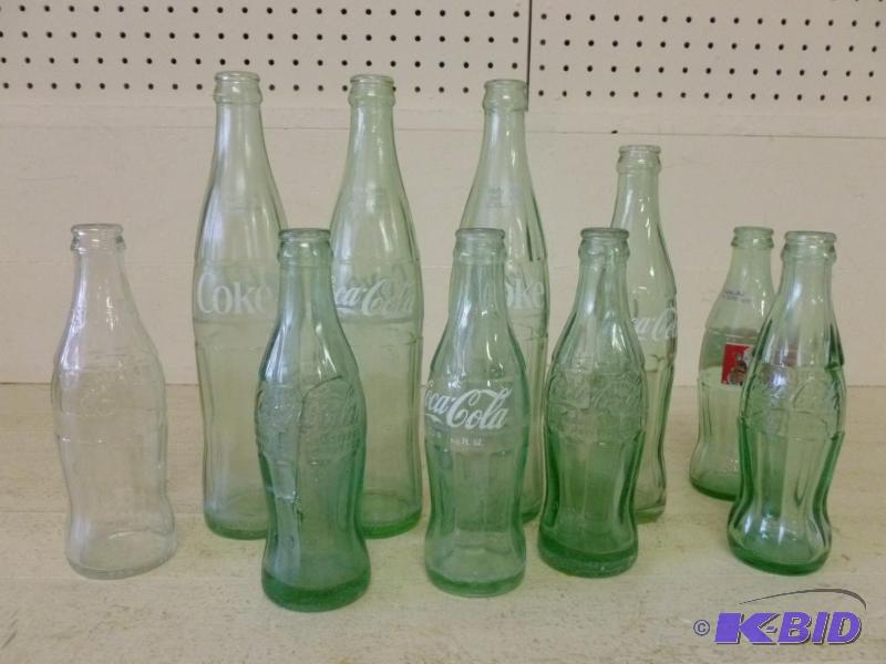 lot 77 image: Lot of ten Coca-Cola mixed sized soda bottles...