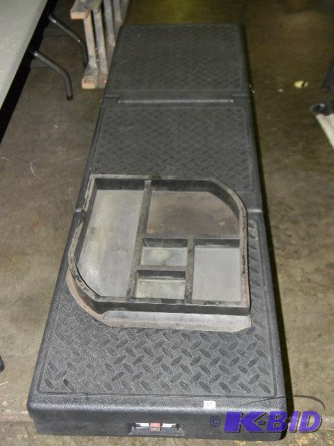 lot 57 image: Truck bed tool box - hardened black plastic...