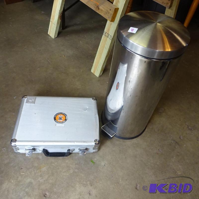 lot 136 image: stainless garbage can. Aluminum gun case has ...