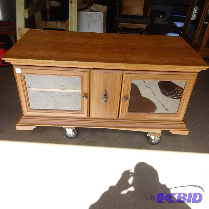 lot 146 image: Laminate Entertainment center. 2 glass doors ...
