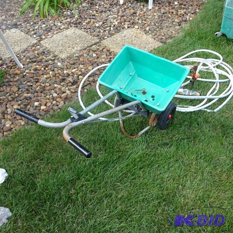 lot 58 image: Red devil lawn spreader. Garden hose. Sprinkl...