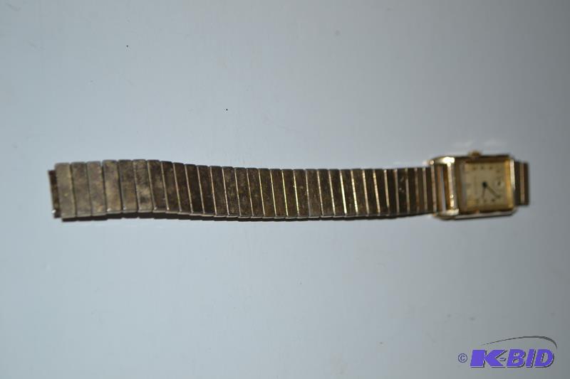 lot 108 image: Bulova 10k gold filled watch. Inside of watch...