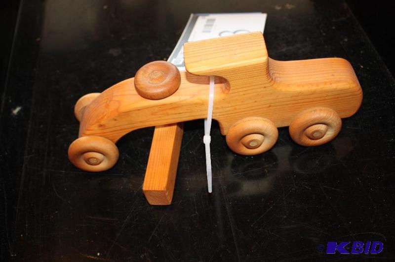 lot 23 image: A wooden toy car...