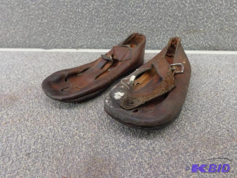 lot 106 image: Old Leather Baby Shoes Buckle across center o...