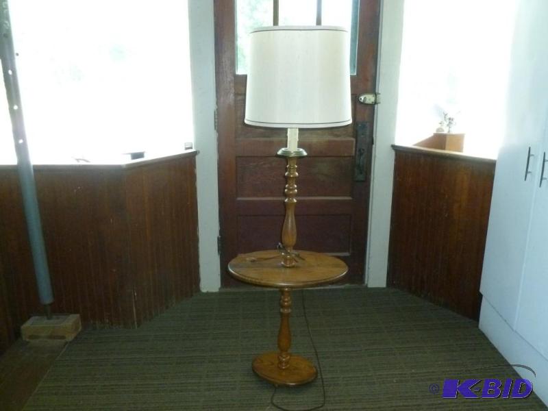 lot 14 image: Large oak bodied floor lamp that measures 57....