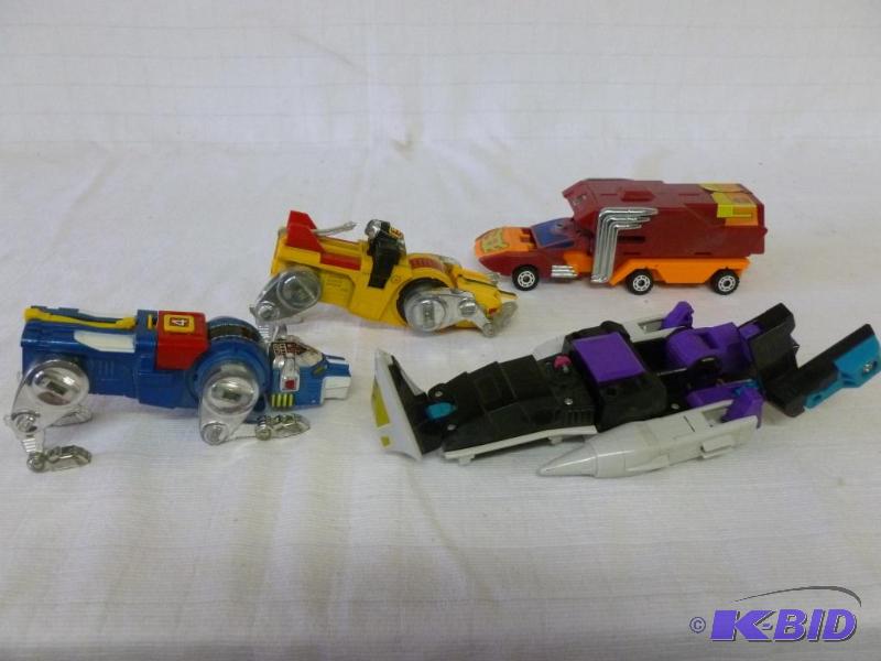 lot 32 image: Lot of four 1980s transformer type toys....