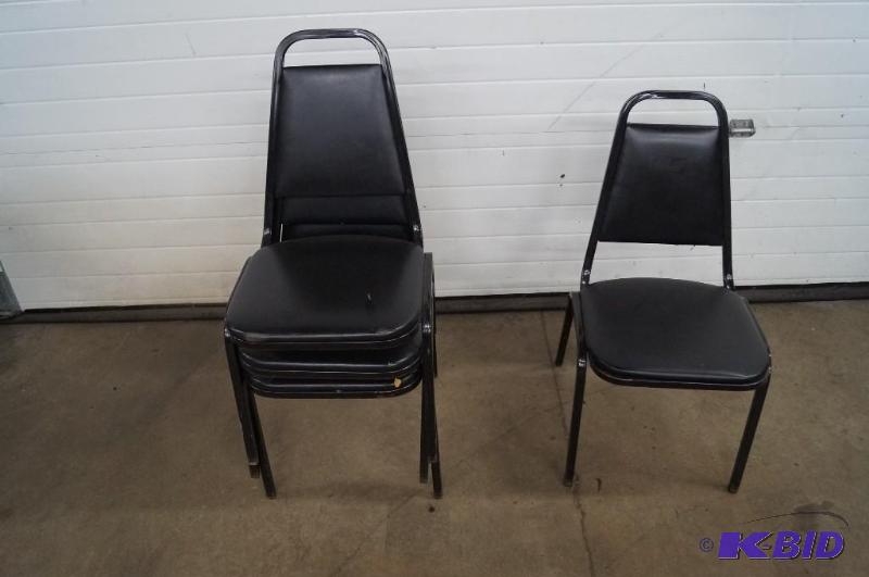Black restaurant stacking chairs and miller light sign