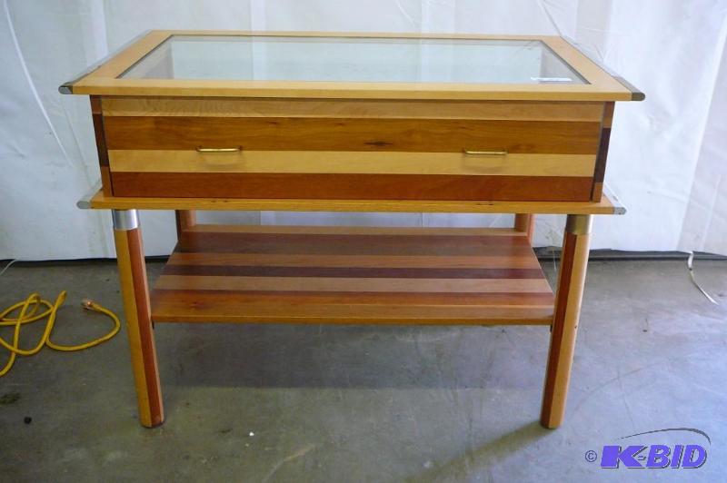 Wooden display table with glass top and front...