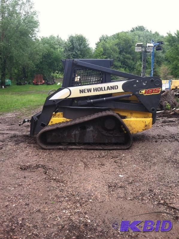 lot 57 image: New Holland C185 Multi Terrain loader. skidsteer, similar to t 250 or t 300 bobcat.