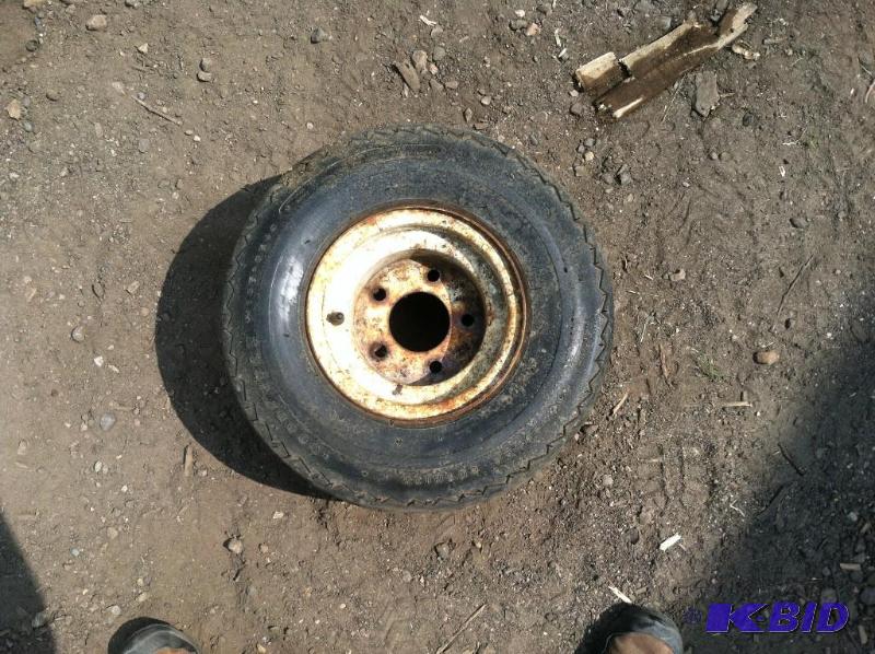 lot 97 image: Trailer Tire and rim.  For snowmobile trailer.