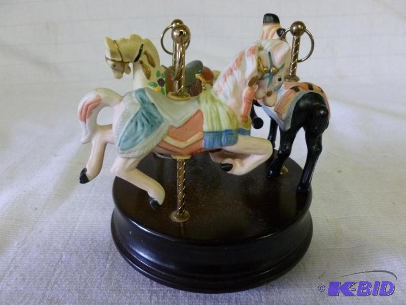 lot 113 image: Decorative porcelain carousal horses on woode...