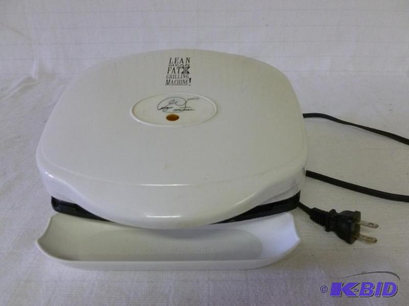 lot 59 image: George Foreman grilling machine, comes with d...