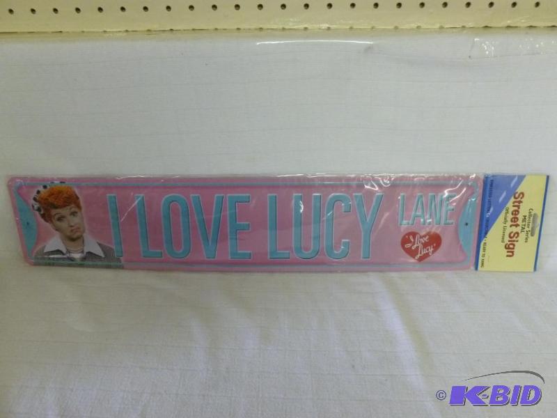 lot 95 image: I Love Lucy embossed metal sign that measures...