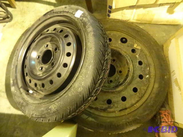 2 car spare tires. 1 is a 5 hole rim. T12570...