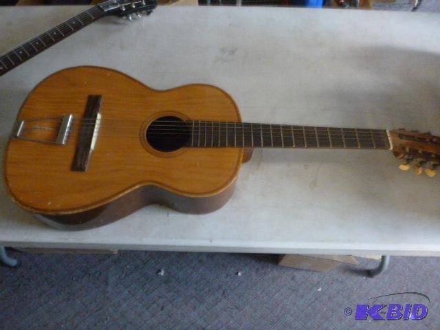 lot 13 image: Acoustic Guitar Missing one string....