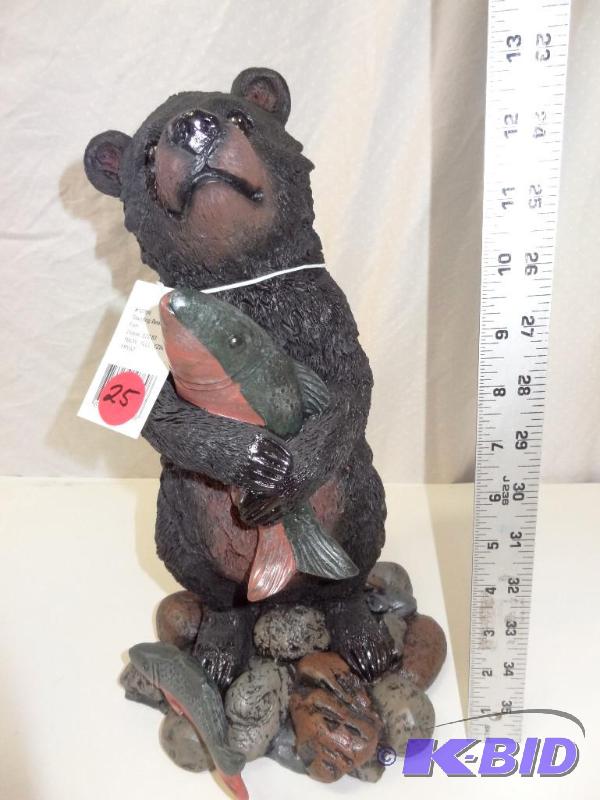 Standing bear holding fish....