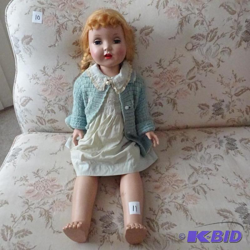 lot 11 image: Very old doll with clothes and ponytails...