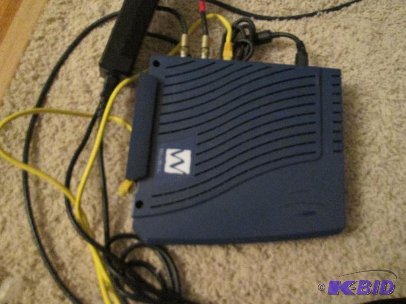 lot 144 image: Wild Blue modem with cables...