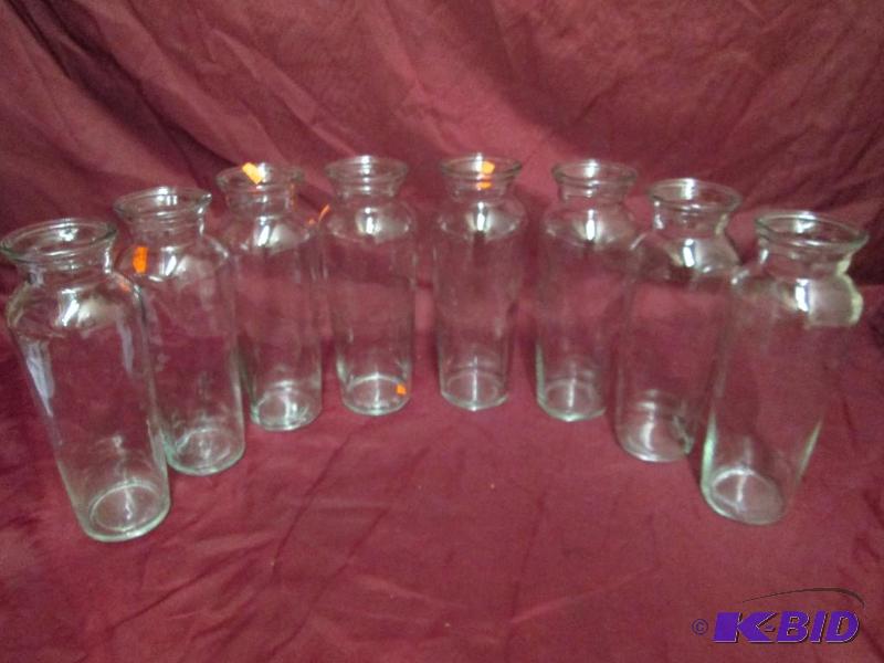 lot 390 image: Lot of 8 clear glass vases. Each is 10 inches...