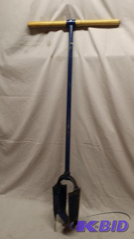 lot 42 image: Post hole digger. Measures about 4 feet long...