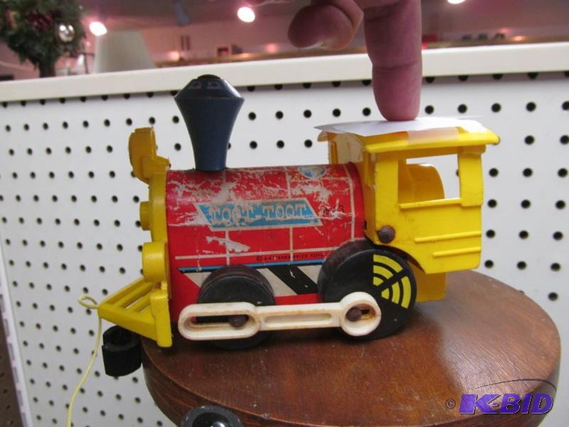lot 27 image: 1964 Fisher Price Toot-Toot Train & Edward Mobley Rubber Dog