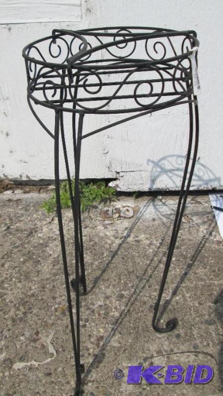 lot 12 image: Metal planter holder, 10 inches across, 29 in...