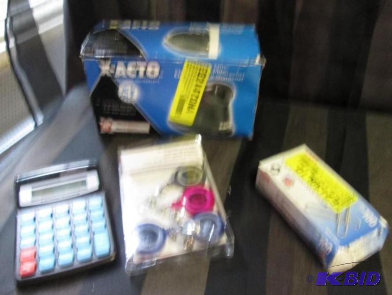 x-acto pencil sharpener, calculator, name tag...