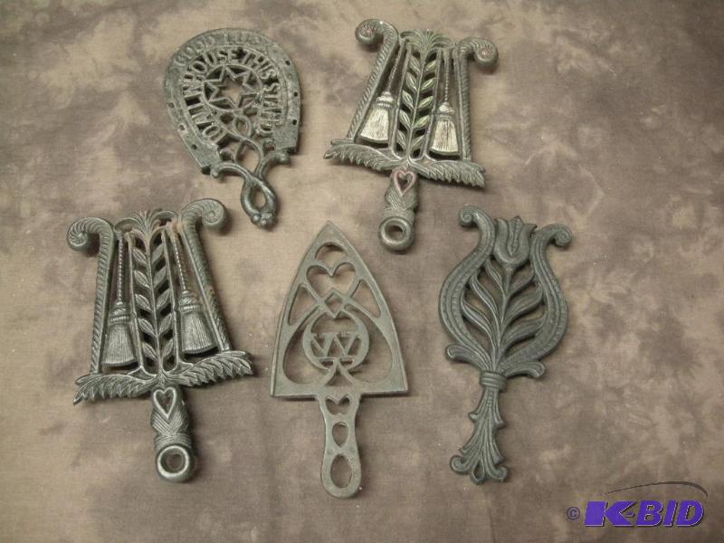 lot 117 image: Group of Wilton cast iron trivets