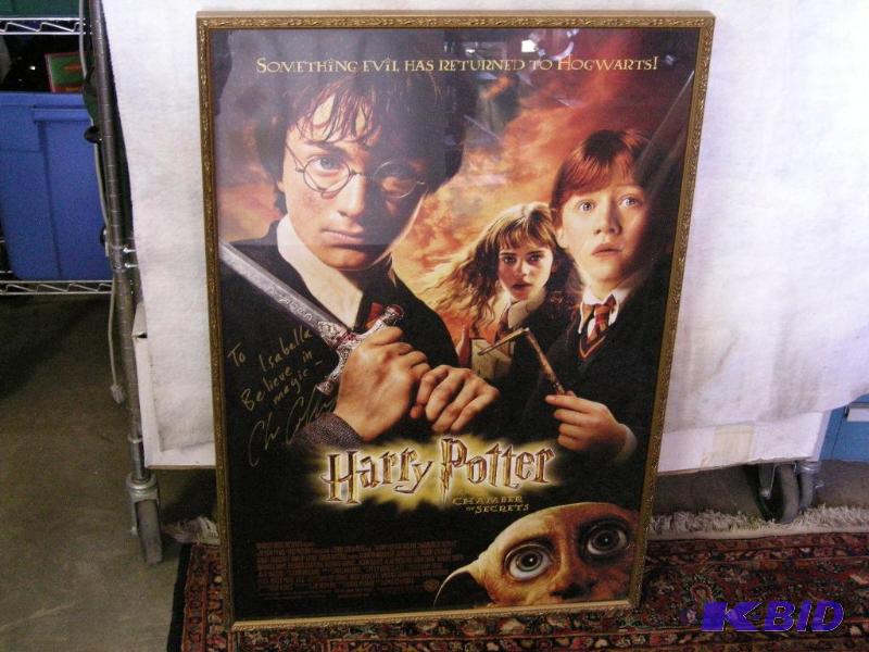 lot 520 image: Harry Potter autographed, framed movie poster. Signed by Director Chris Columbus.