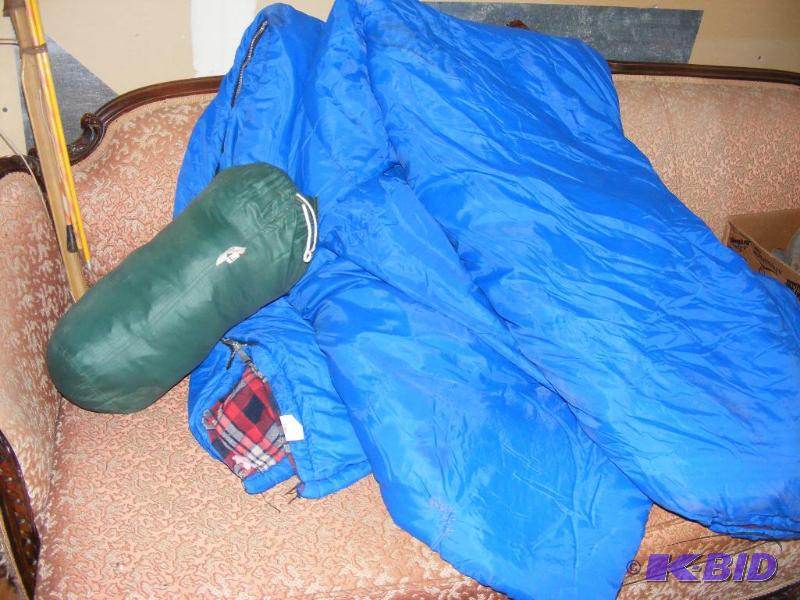 lot 17 image: Two blue sleeping bags and a jacket in a pouc...