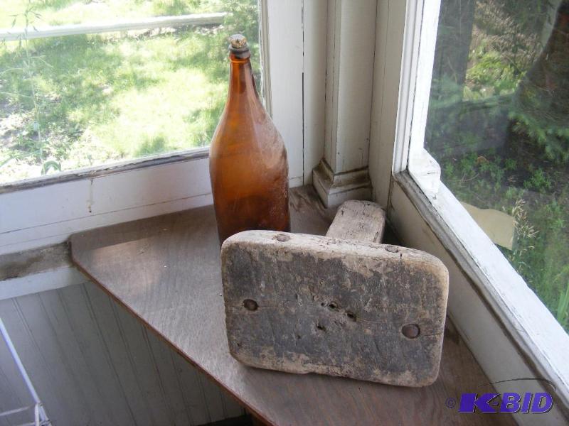 lot 185 image: Old one legged milk stool and brown glass bot...
