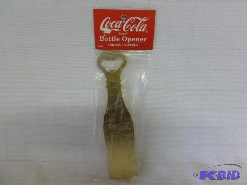lot 144 image: Large Coca-Cola brass plated metal bottle ope...